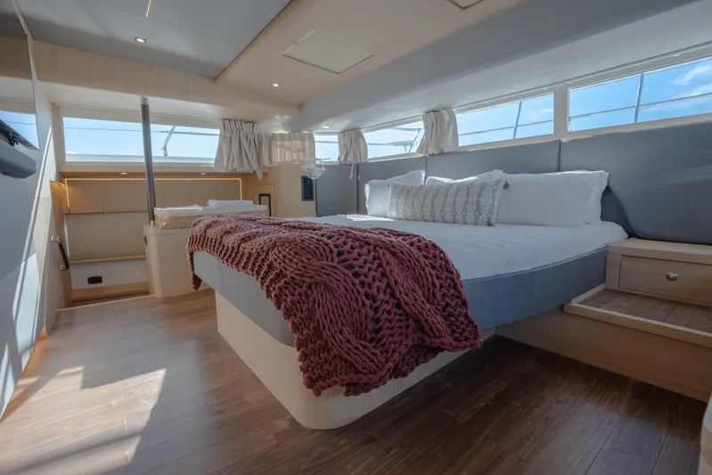  Yacht Photos Pics Luxurious bedroom interior of 2025 Aquila 54 Yacht with modern design and cozy bedding.