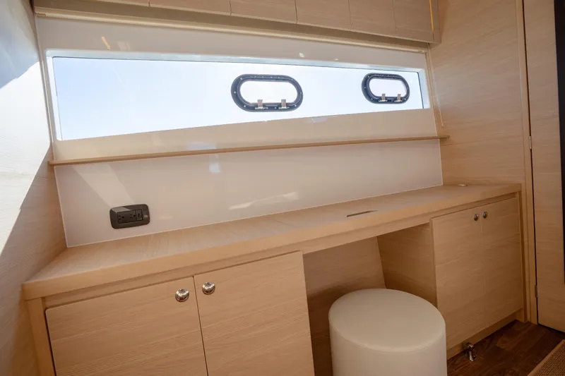  Yacht Photos Pics Luxurious interior of 2025 Aquila 54 Yacht with sleek wooden desk and modern design.