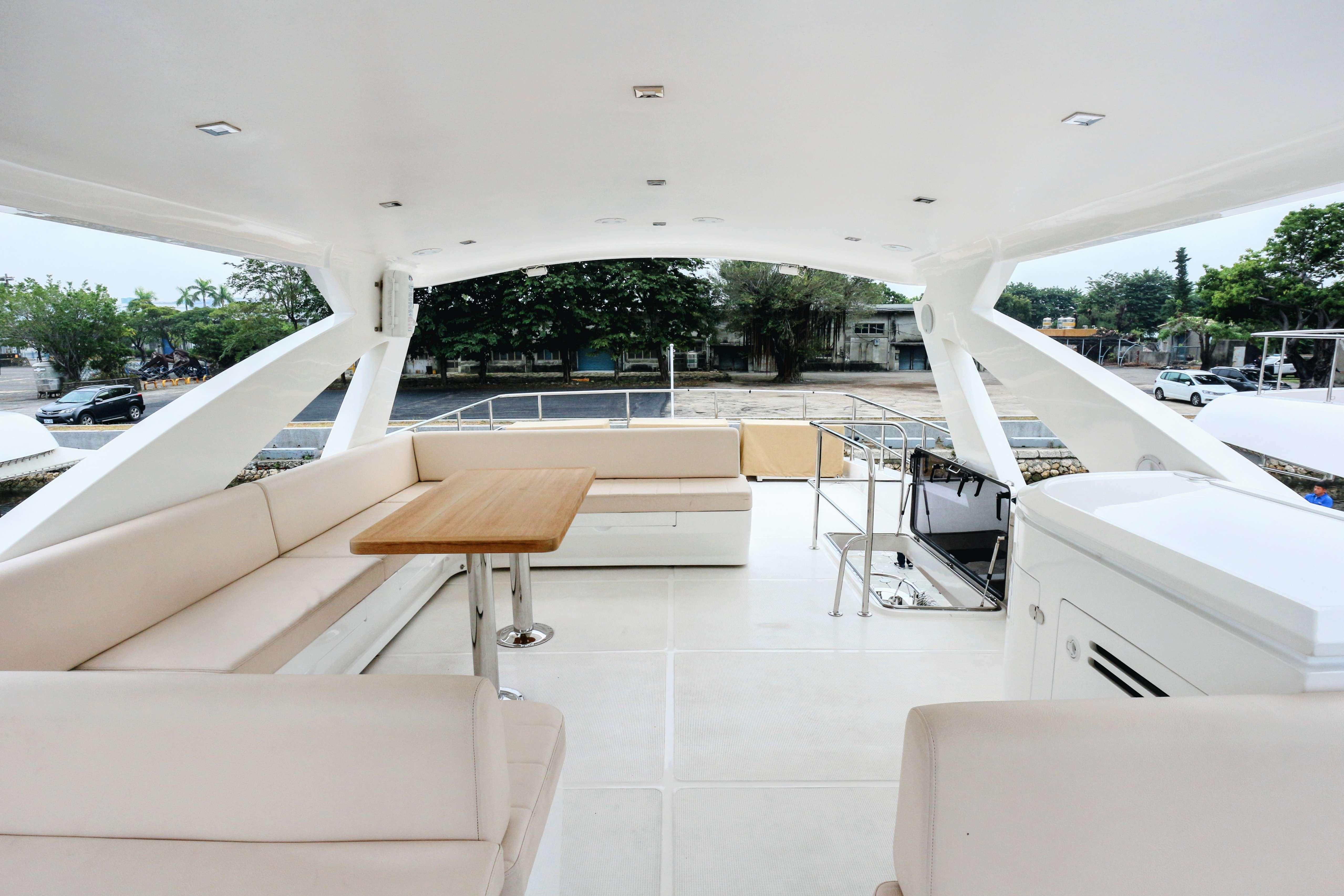 Luxurious 2019 Ruby 72 yacht deck with seating and dining area.