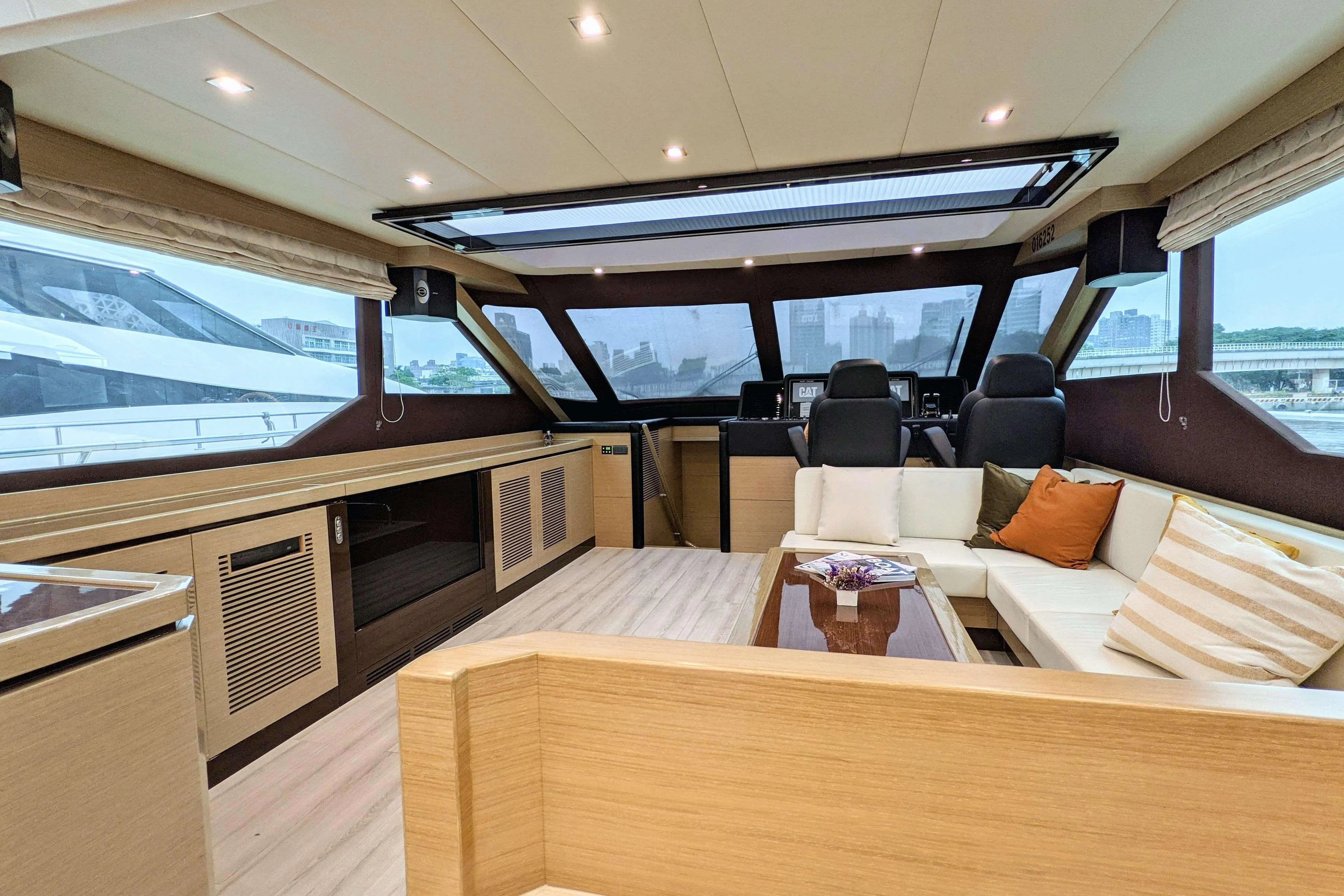 Luxurious interior of 2019 Ruby 72 yacht with modern seating and panoramic windows.