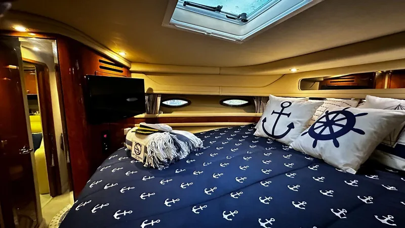 Sea Me Yacht Photos Pics Luxurious cabin interior of 2000 Sea Ray 460 Sundancer with nautical-themed bedding.