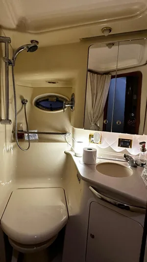 Sea Me Yacht Photos Pics Bathroom interior of 2000 Sea Ray 460 Sundancer yacht, featuring shower and sink.