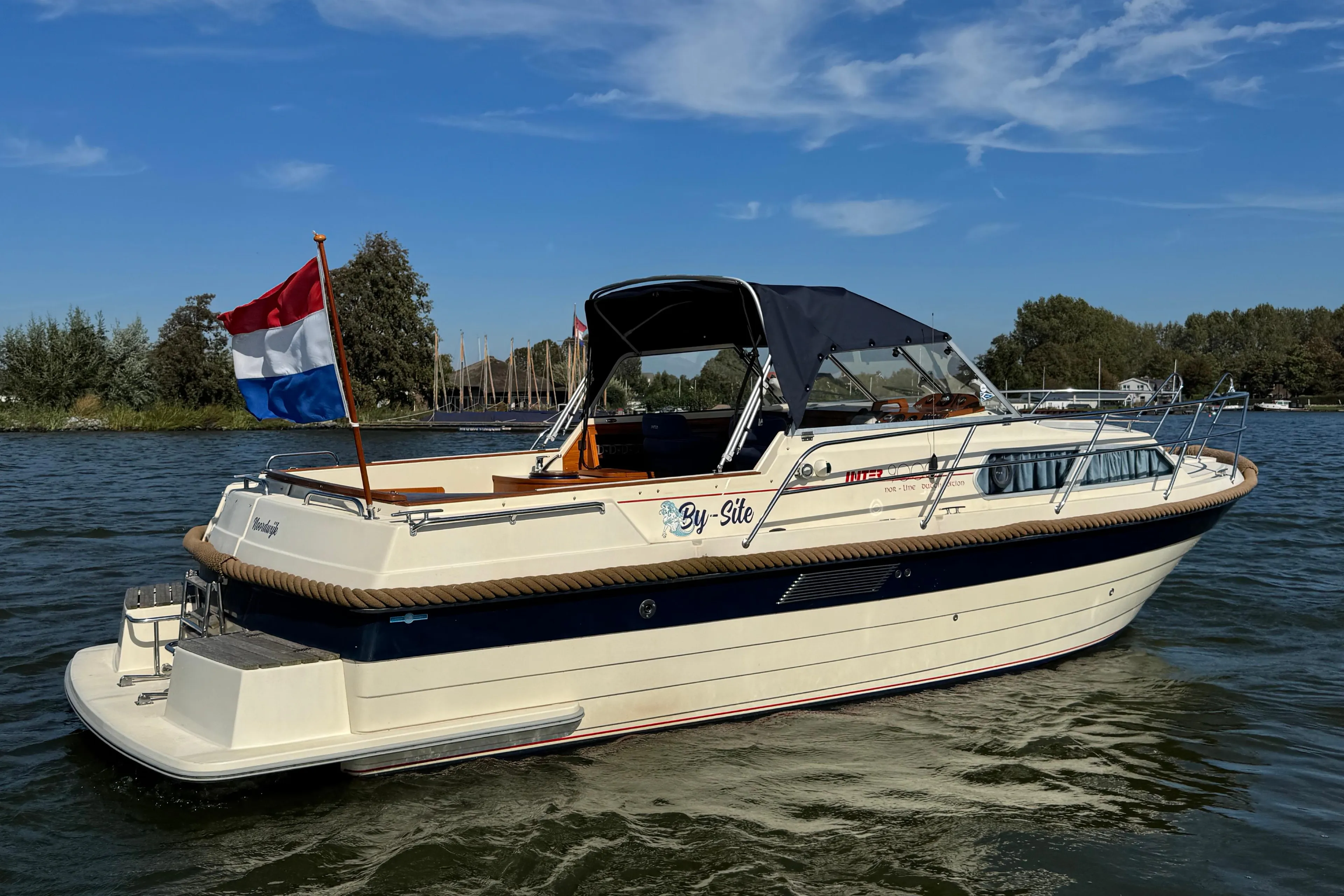 2008 INTER 9000 Sportivo boat on water with Dutch flag, clear sky background.
