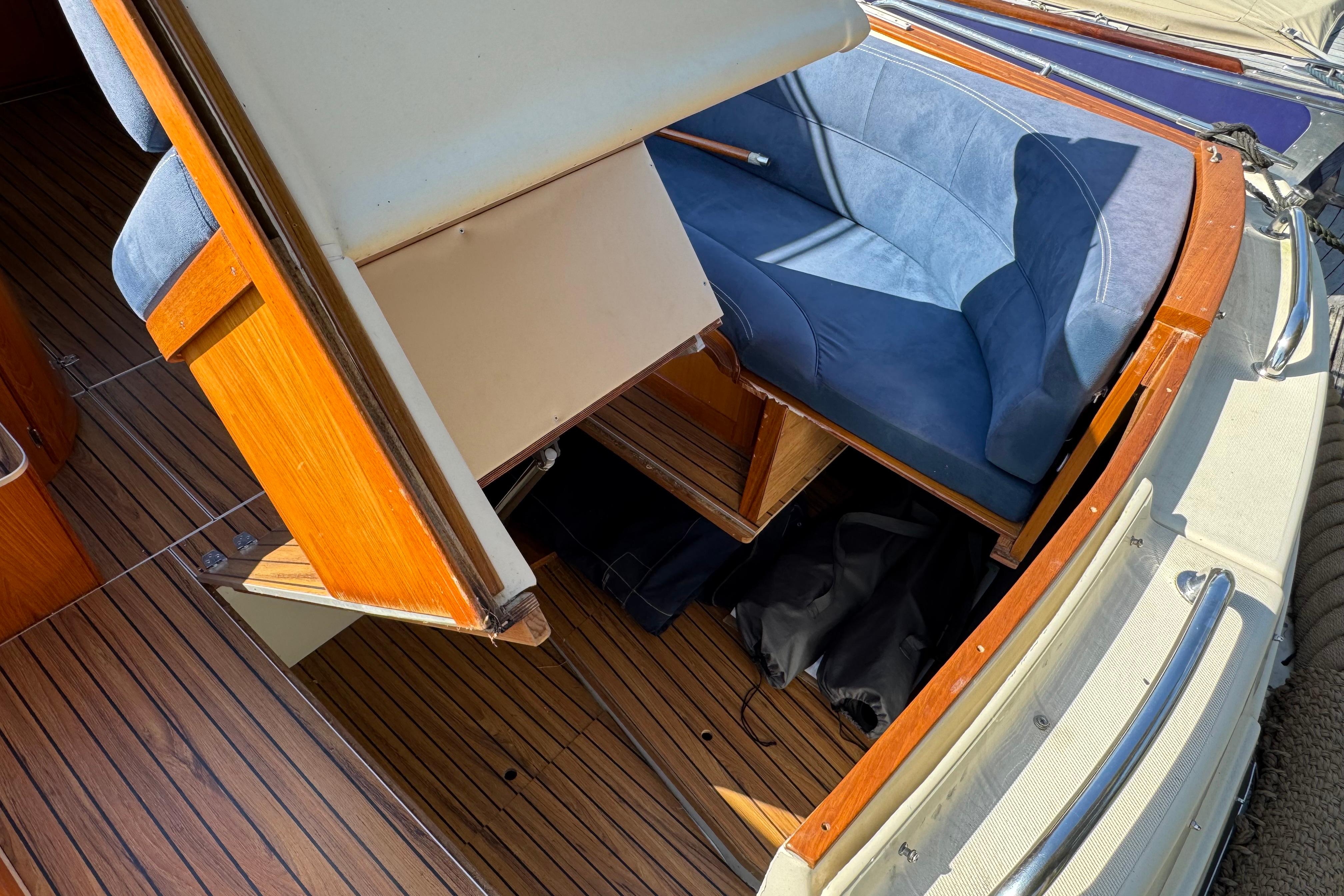Interior of 2008 INTER 9000 Sportivo boat with wooden flooring and blue seating.