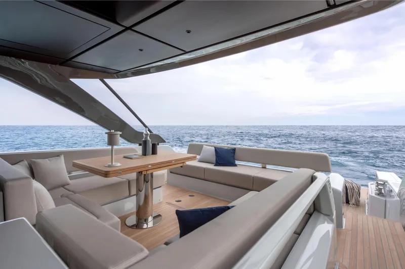  Yacht Photos Pics Luxurious 2025 Bluegame BG54 yacht interior with ocean view, featuring elegant seating and table.