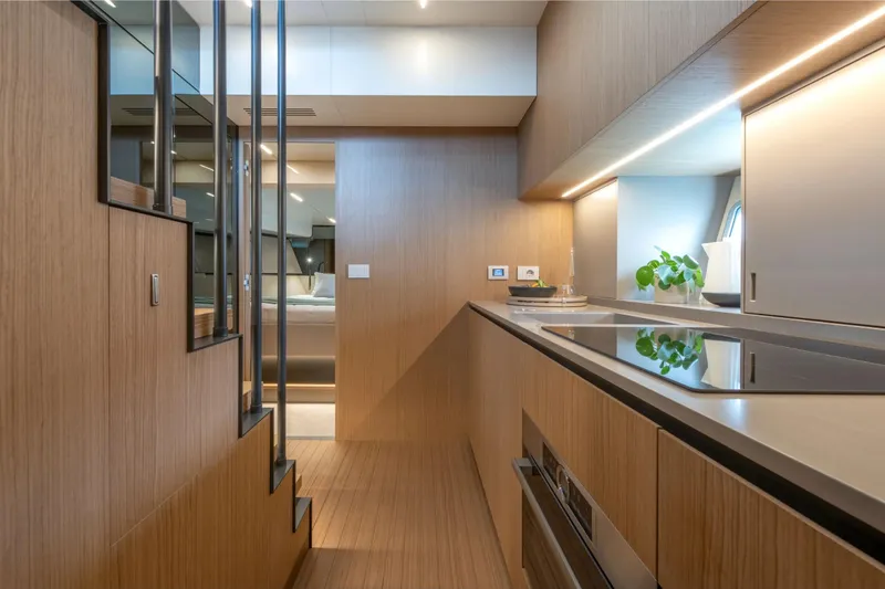  Yacht Photos Pics Modern interior of 2025 Bluegame BG54 yacht with sleek kitchen design and wooden finishes.