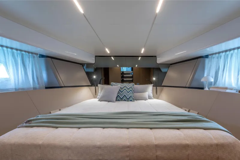  Yacht Photos Pics Luxurious interior of 2025 Bluegame BG54 yacht with elegant bedding and modern lighting.