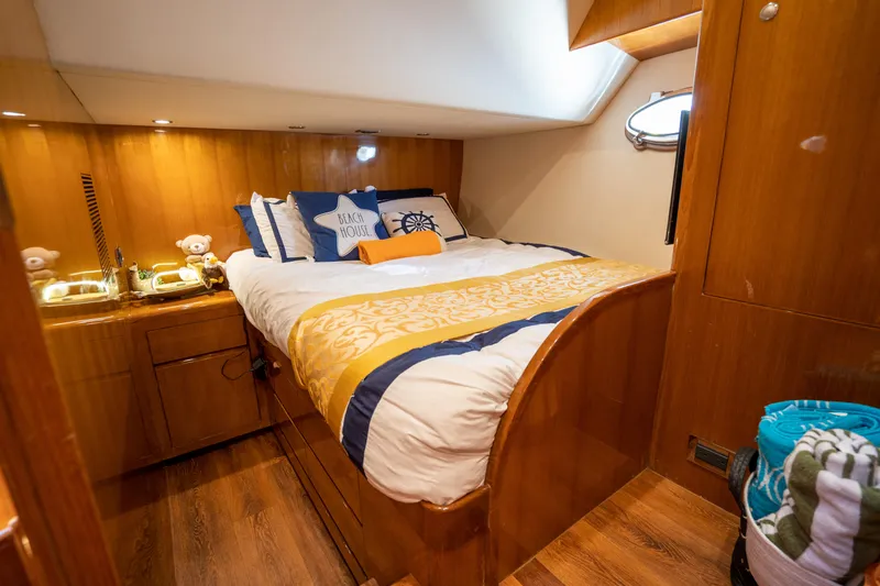  Yacht Photos Pics Luxurious cabin interior of 2007 Ocean Alexander 52 Pilothouse yacht with cozy bedding.