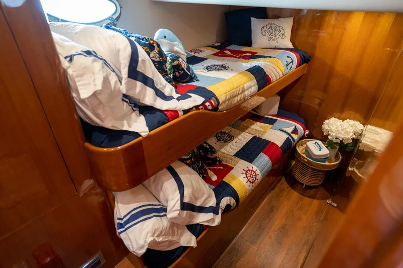  Yacht Photos Pics Bunk beds in 2007 Ocean Alexander 52 Pilothouse, featuring nautical-themed bedding and wooden interior.