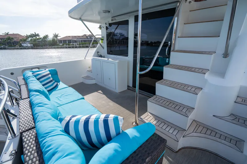  Yacht Photos Pics Luxurious 2007 Ocean Alexander 52 Pilothouse yacht deck with blue seating and striped cushions.