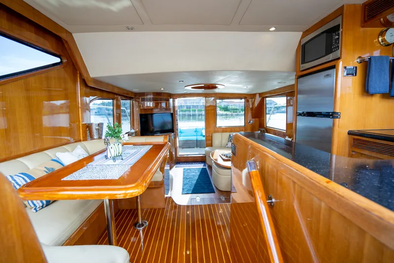  Yacht Photos Pics Luxurious interior of 2007 Ocean Alexander 52 Pilothouse yacht with elegant wood finishes.