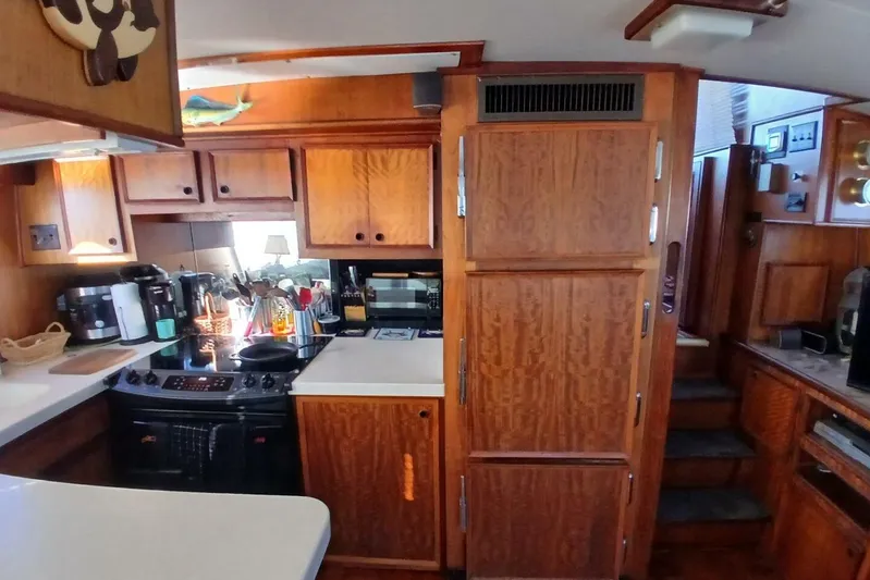 Concrete Idea Yacht Photos Pics 1977 Hatteras 48 Long Range Cruiser kitchen with wooden cabinetry and modern appliances.