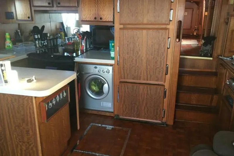 Concrete Idea Yacht Photos Pics 1977 Hatteras 48 Long Range Cruiser kitchen with wood cabinetry and compact appliances.