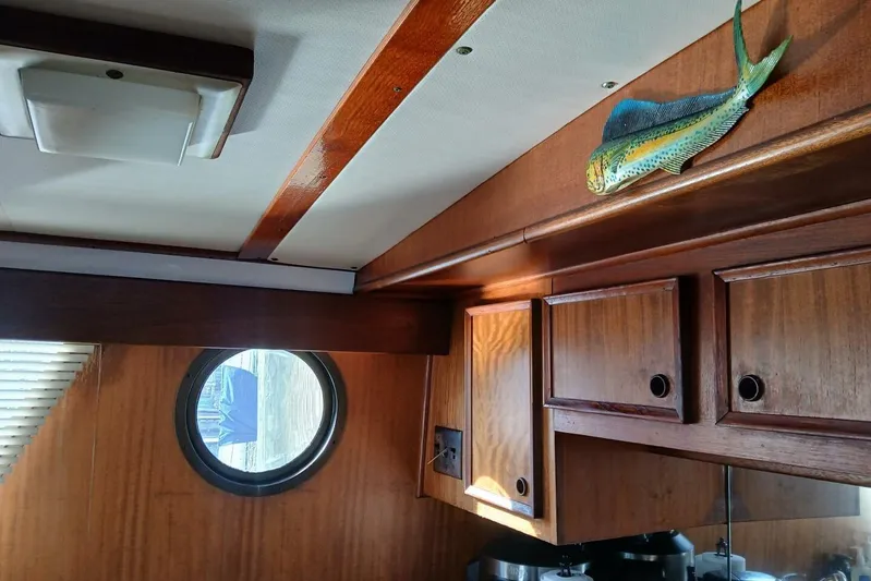 Concrete Idea Yacht Photos Pics Interior of 1977 Hatteras 48 Long Range Cruiser with wood cabinets and fish decor.