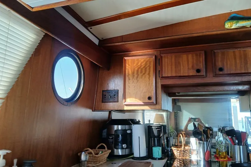 Concrete Idea Yacht Photos Pics Interior of 1977 Hatteras 48 Long Range Cruiser with wooden cabinets and kitchen appliances.