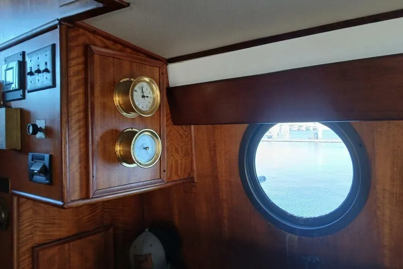 Concrete Idea Yacht Photos Pics Interior of 1977 Hatteras 48 Long Range Cruiser with porthole and brass instruments.