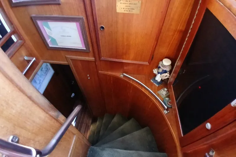 Concrete Idea Yacht Photos Pics Interior of 1977 Hatteras 48 Long Range Cruiser with wooden staircase and nautical decor.