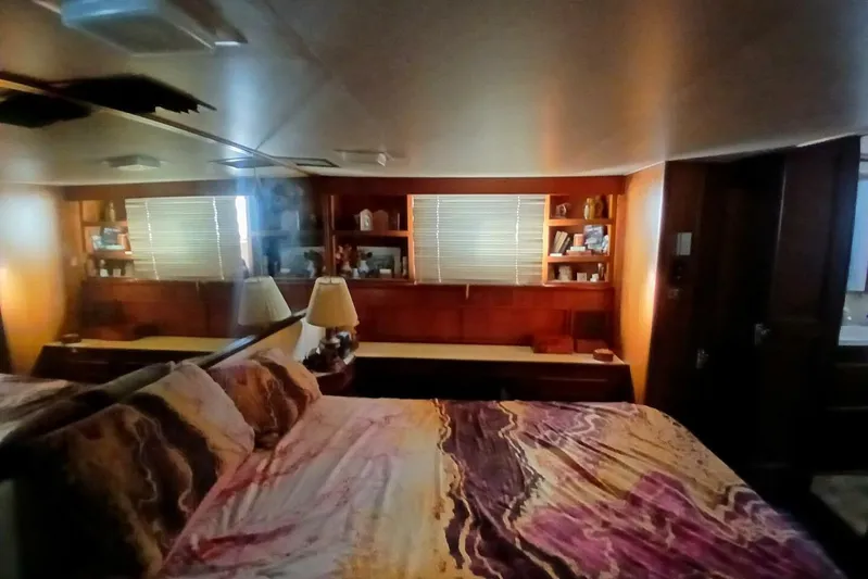 Concrete Idea Yacht Photos Pics Cozy bedroom interior of 1977 Hatteras 48 Long Range Cruiser with wood paneling and soft lighting.