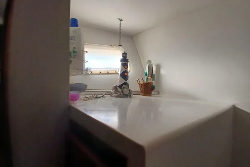 Concrete Idea Yacht Photos Pics 1977 Hatteras 48 Long Range Cruiser interior with toiletries and window view.