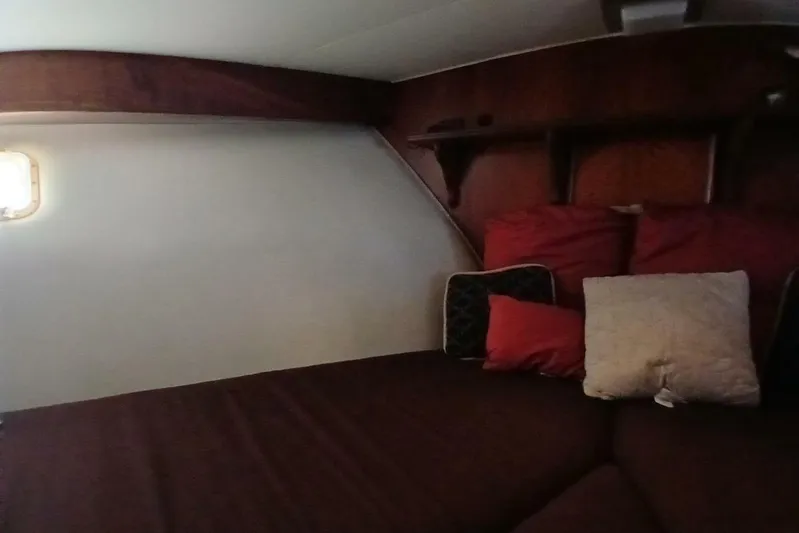 Concrete Idea Yacht Photos Pics Cozy cabin interior of 1977 Hatteras 48 Long Range Cruiser with cushions and wooden shelves.