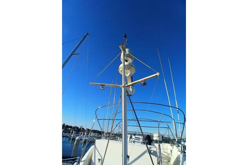 Concrete Idea Yacht Photos Pics 1977 Hatteras 48 Long Range Cruiser mast against clear blue sky at marina.