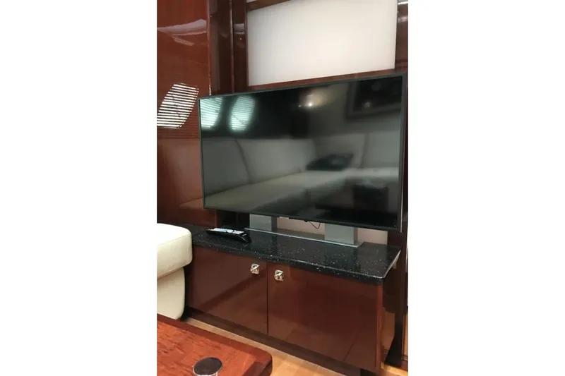 Ocean Blue III Yacht Photos Pics Flat-screen TV in 2010 Sea Ray Sundancer 540 yacht interior, mounted on a wooden cabinet.