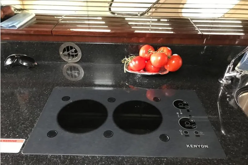 Ocean Blue III Yacht Photos Pics Modern yacht kitchen with Kenyon cooktop and fresh tomatoes on Sea Ray Sundancer 540, 2010.