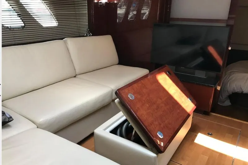 Ocean Blue III Yacht Photos Pics Luxurious interior of 2010 Sea Ray Sundancer 540 yacht with cream sofa and TV.