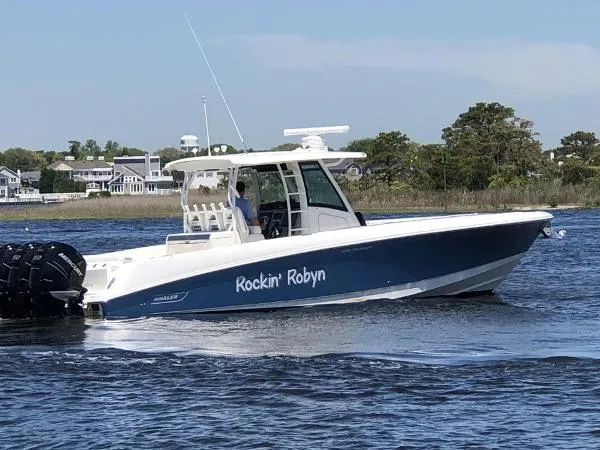  Yacht Photos Pics 2016 Boston Whaler 350 Outrage boat named "Rockin' Robyn" cruising on a calm waterway.