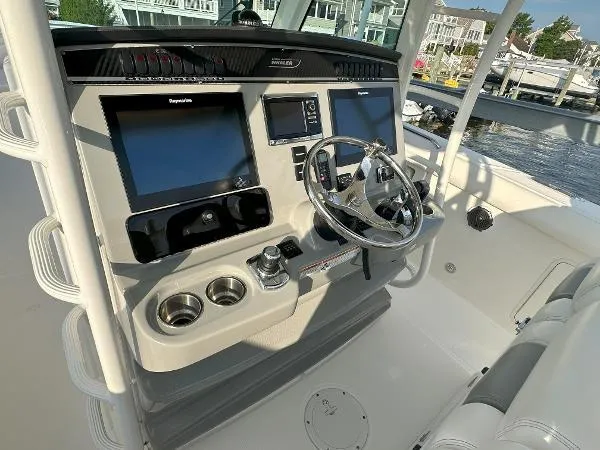  Yacht Photos Pics 2016 Boston Whaler 350 Outrage helm with dual screens and steering wheel, dockside view.
