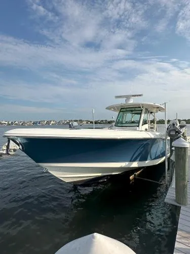  Yacht Photos Pics 2016 Boston Whaler 350 Outrage boat docked on a sunny day.