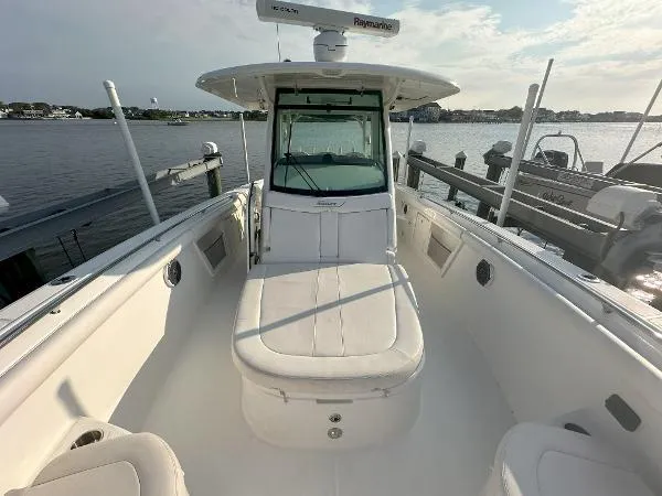  Yacht Photos Pics 2016 Boston Whaler 350 Outrage boat docked by the water, showcasing spacious seating.
