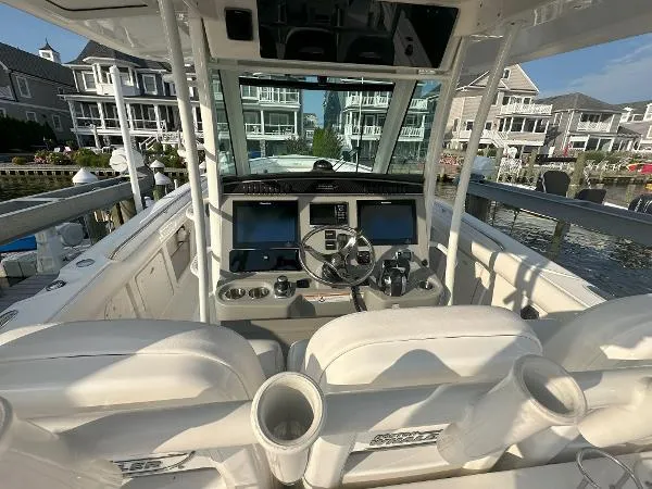  Yacht Photos Pics 2016 Boston Whaler 350 Outrage boat cockpit with modern controls and waterfront view.