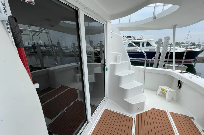  Yacht Photos Pics 2000 Mainship 390 Trawler with wooden deck, docked at marina, featuring spiral staircase.