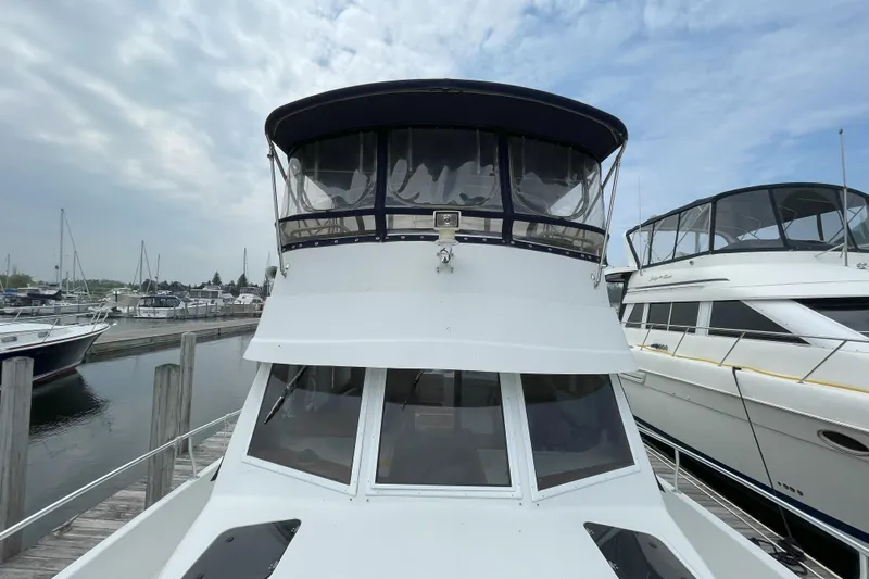  Yacht Photos Pics 2000 Mainship 390 Trawler docked at marina, showcasing front view and upper deck.