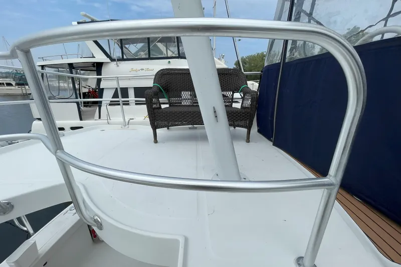  Yacht Photos Pics 2000 Mainship 390 Trawler deck with railing and wicker chair.