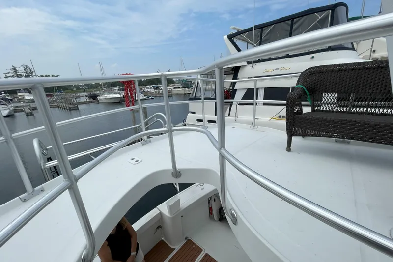  Yacht Photos Pics 2000 Mainship 390 Trawler docked at marina, featuring upper deck and railing.