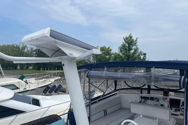  Yacht Photos Pics 2000 Mainship 390 Trawler with radar, docked near trees and other boats.