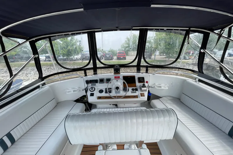  Yacht Photos Pics 2000 Mainship 390 Trawler helm with white seating and panoramic windows.