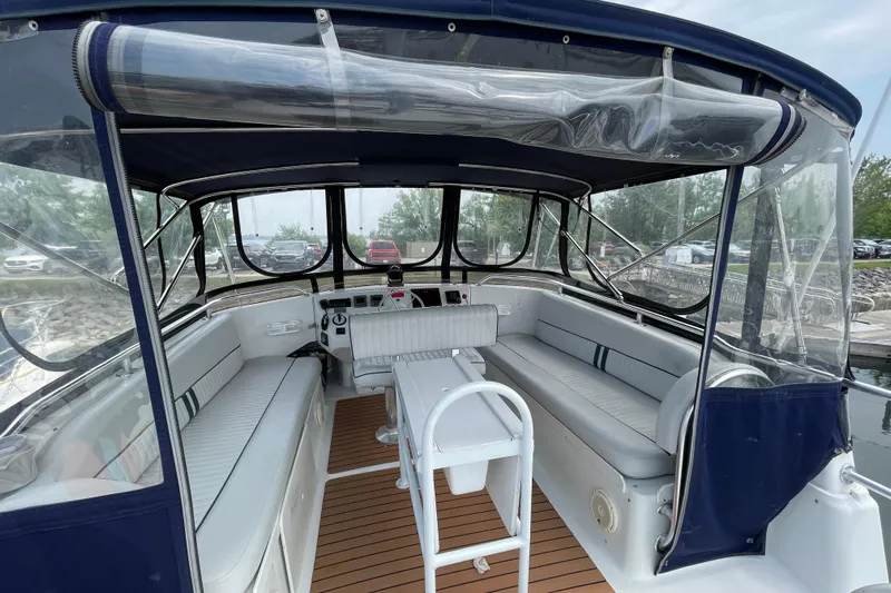  Yacht Photos Pics 2000 Mainship 390 Trawler interior with seating and helm, featuring clear canopy and wood flooring.