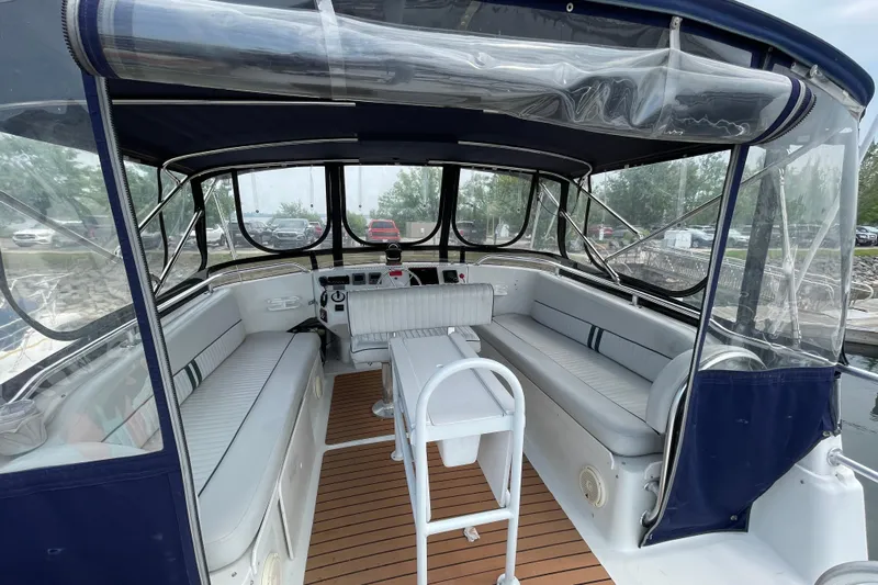  Yacht Photos Pics 2000 Mainship 390 Trawler interior with seating, helm, and clear canopy.