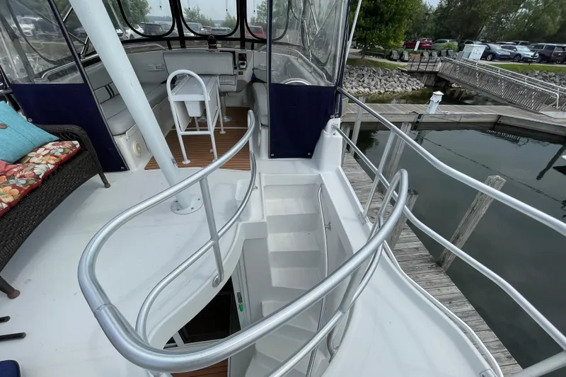  Yacht Photos Pics 2000 Mainship 390 Trawler interior with helm, seating, and dock view.