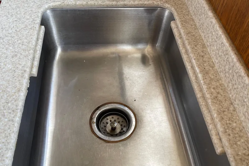  Yacht Photos Pics Stainless steel sink on 2000 Mainship 390 Trawler with beige countertop.