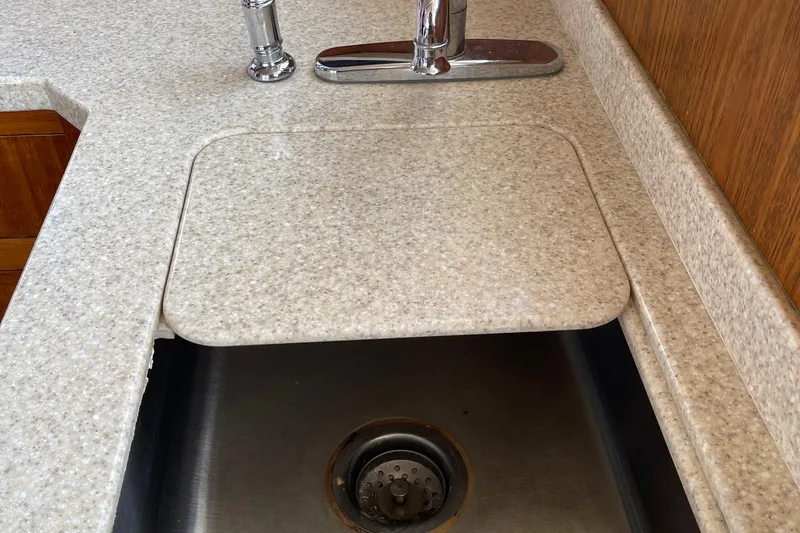  Yacht Photos Pics Kitchen sink with cover on a 2000 Mainship 390 Trawler boat.