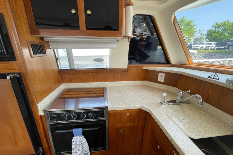  Yacht Photos Pics 2000 Mainship 390 Trawler kitchen with wood cabinetry and modern appliances.
