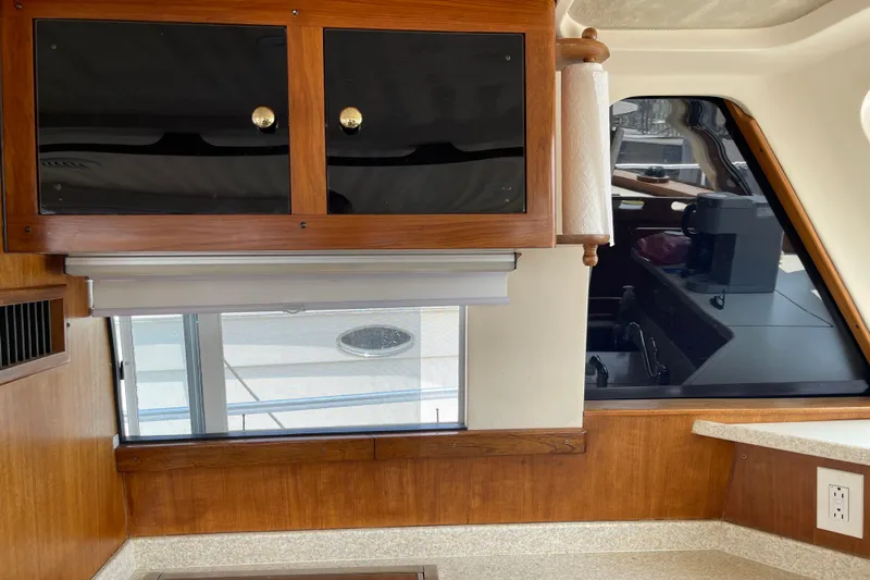  Yacht Photos Pics Interior of 2000 Mainship 390 Trawler with wooden cabinets and countertop.