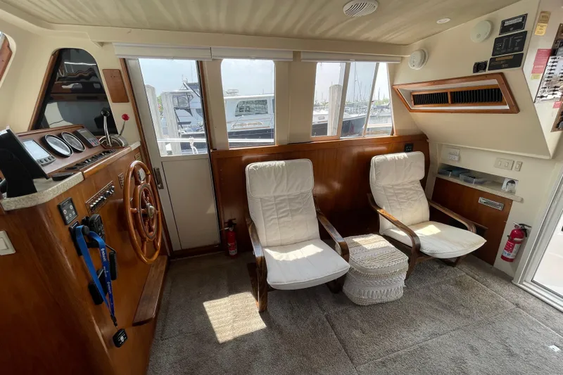  Yacht Photos Pics Interior of 2000 Mainship 390 Trawler with helm, chairs, and nautical decor.