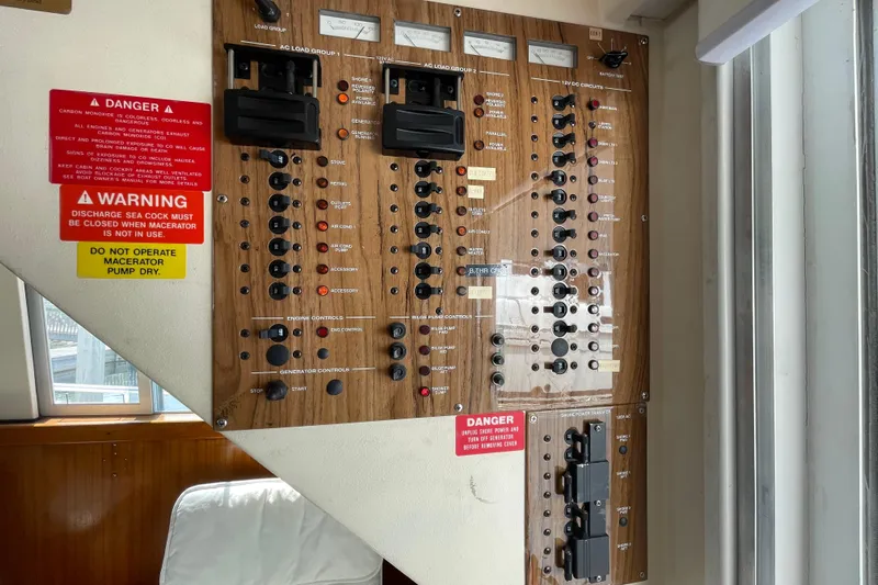  Yacht Photos Pics Electrical control panel on a 2000 Mainship 390 Trawler with warning labels.