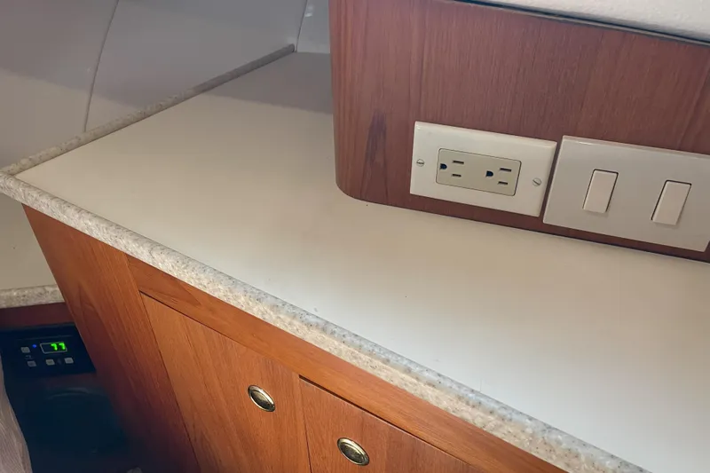  Yacht Photos Pics Interior of 2000 Mainship 390 Trawler with countertop, electrical outlet, and switches.