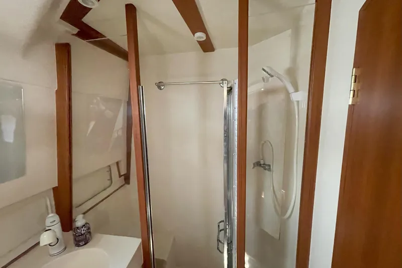  Yacht Photos Pics Bathroom interior of 2000 Mainship 390 Trawler with shower and sink.